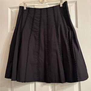 Isaac Mizrahi black a-line skit with lace detail. Size 4.